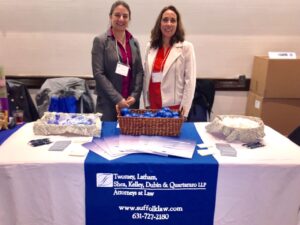 partner attorneys Anne Marie Goodale and Laura Dunathan in front of Twomey Latham booth table