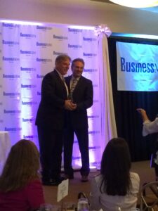 Christopher Kelley accepting leadership excellence award